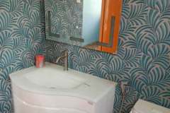 hanging-wash-basin-with-lighted-mirror-on-palm-design-bathroom-tiles